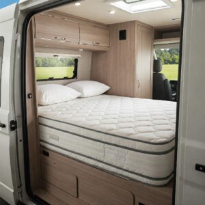 A rv king mattress 72x80 fitting perfectly in a camper van bedroom.