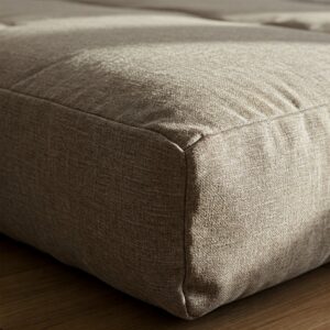 Close-up view of the durable fabric and comfortable filling of a twin futon mattress.