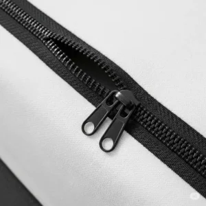 A detailed view of a secure zipper on a mattress encasement, designed to fully protect a bed mattress cover from all sides.

