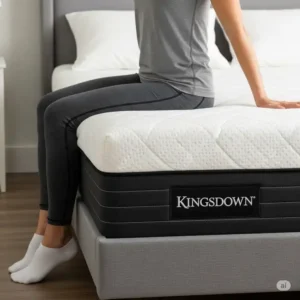 An illustration or photo demonstrating strong edge support on a Kingsdown mattress, showing minimal sinkage when someone sits on the edge, a common point in kingsdown mattress reviews for durability and usability.