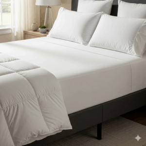 A fully made bed featuring a 54x75 mattress with crisp white sheets, a comforter, and pillows, showing how the mattress fits standard bedding.