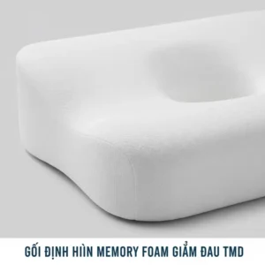 A close-up of a contoured memory foam pillow, highlighting the neck support area essential for relieving pain for TMJ sufferers.