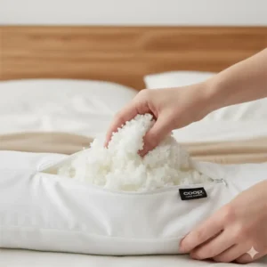 Close-up of a hand opening the zipper to adjust the loft and firmness of the Coop Home Goods pillow, a key feature in this Coop Home Goods pillow review.